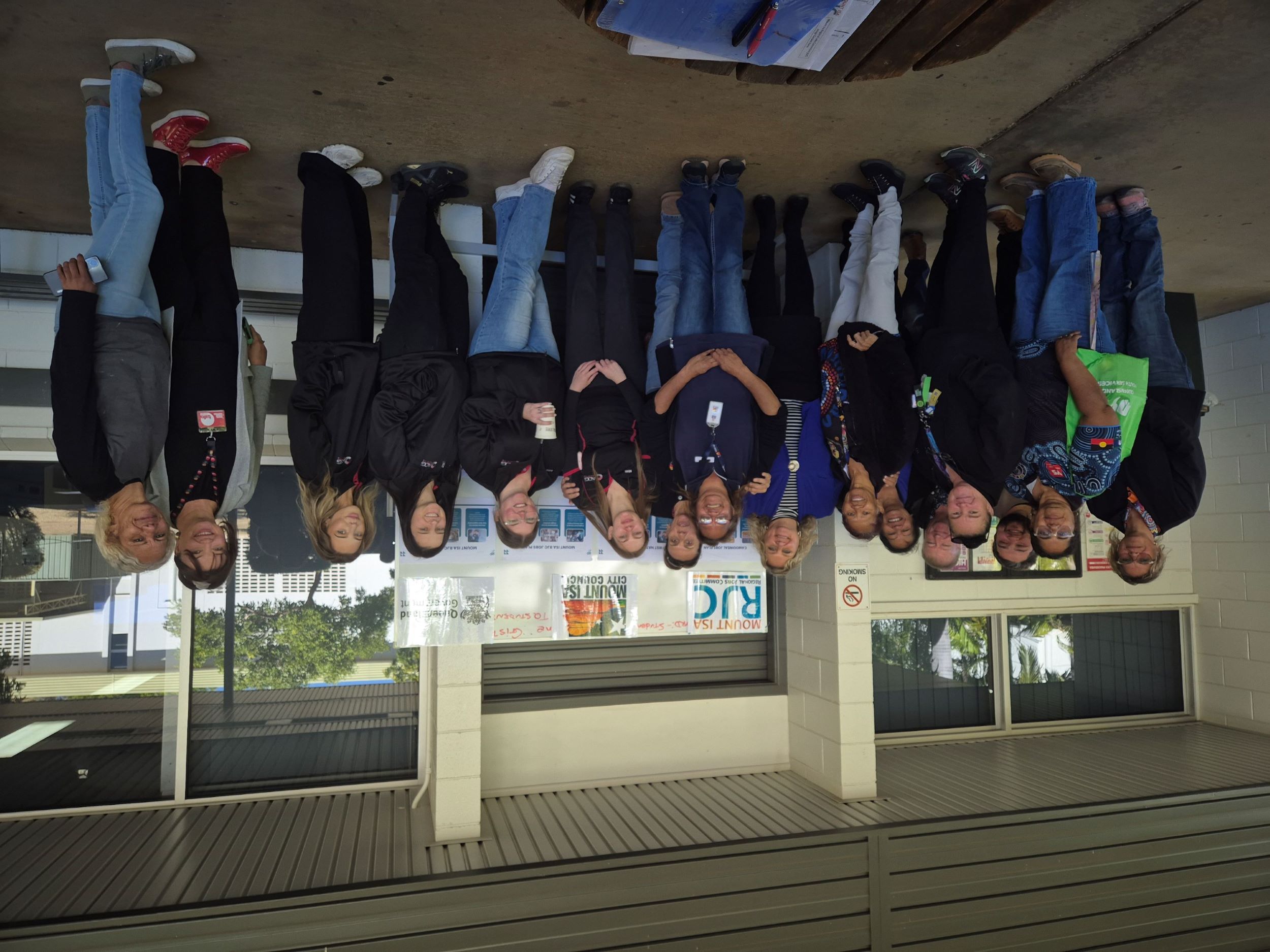 A diverse group of community members, RJC Committee representatives, working group participants, and local stakeholders gathered indoors, smiling and engaged during the Mount Isa Regional Jobs Committee Reflections and Celebrations event.